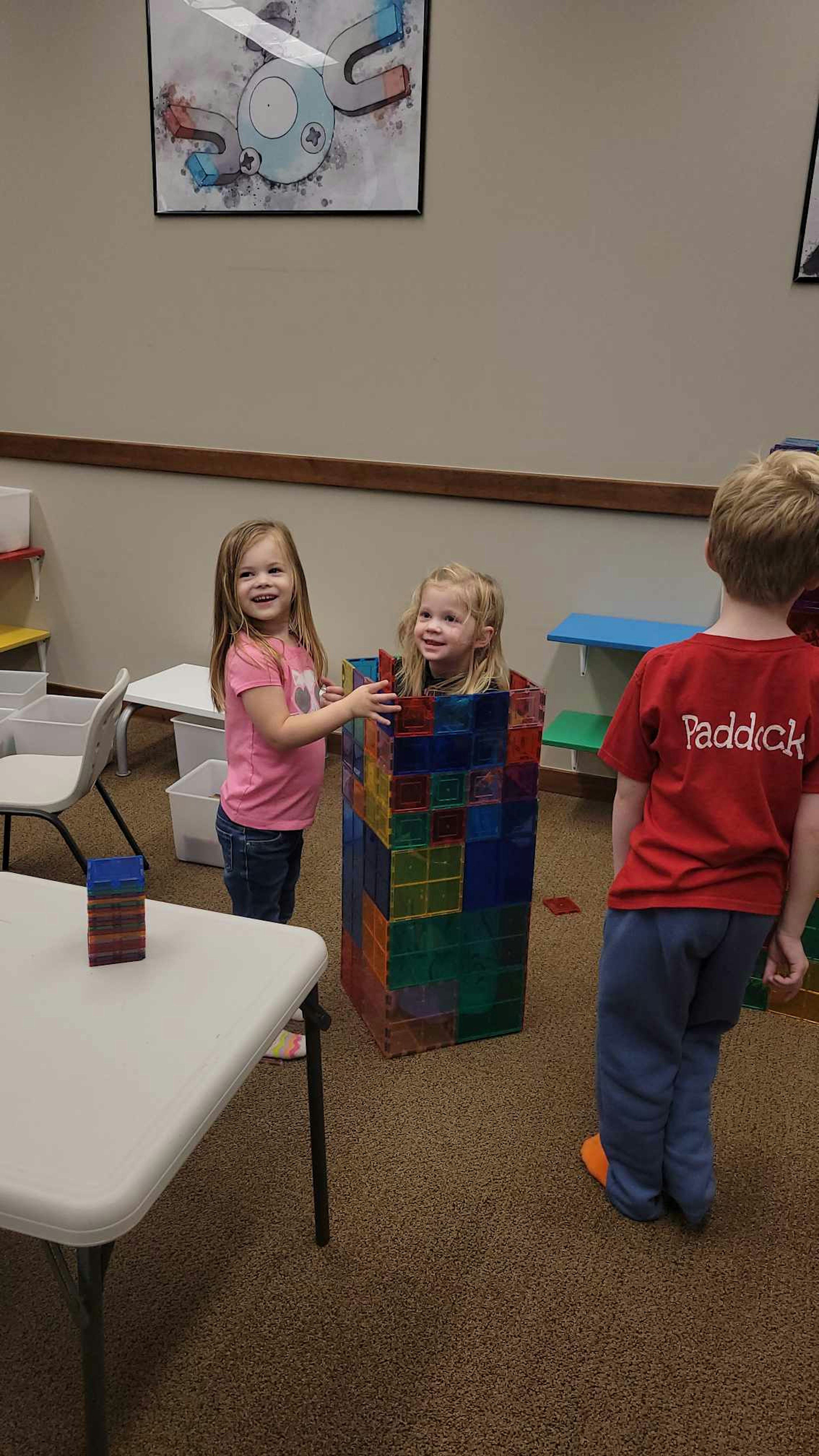 Enclosing a child with magnet tiles