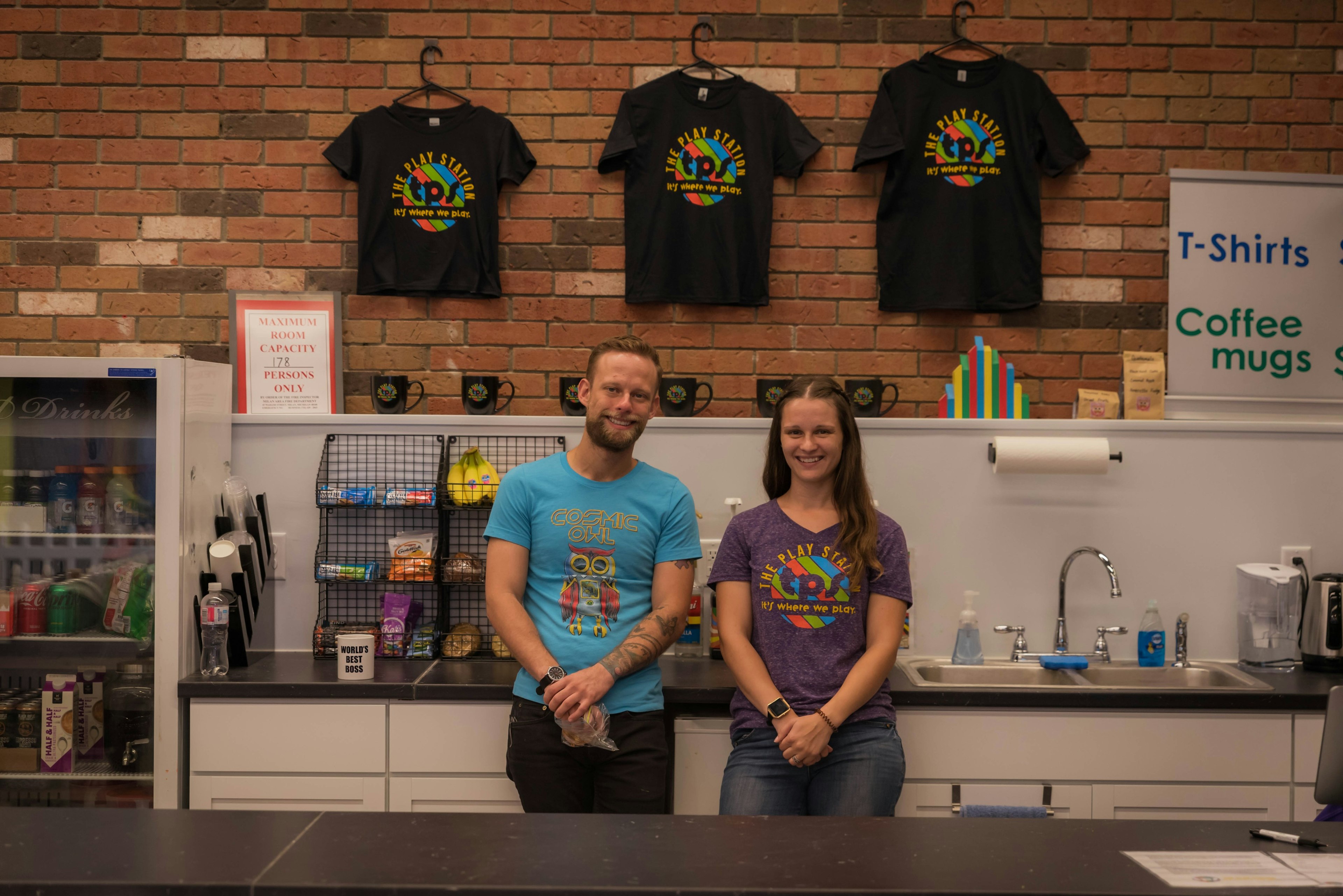 Garrison and Olivia behind the counter at The Play Station.