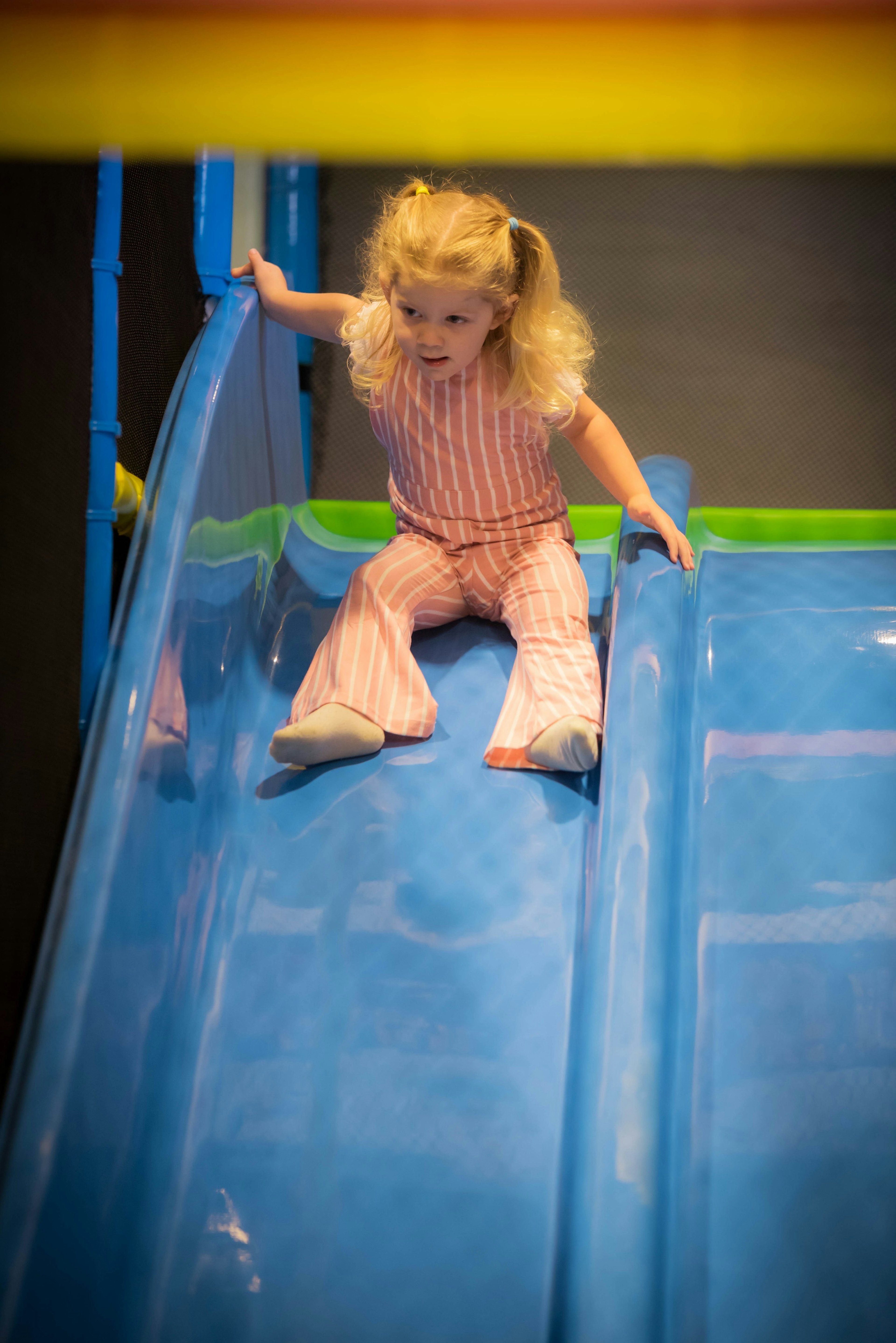 Going down the slide on the play structure.